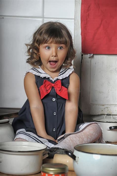 Little Brunette Girl With Curls In A Marine Suit Dress In The Kitchen Stock Image Image Of