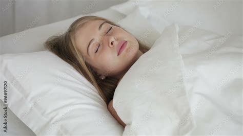 Pretty Girl Sleeping On Her Back In Bed Turning On Her Side And Smiling Panning Camera Stock