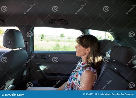 Woman Sitting In The Backseat Of A Car Stock Photo Image Of