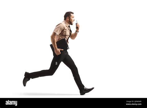 Full Length Profile Shot Of A Security Guard Running And Using A Walkie