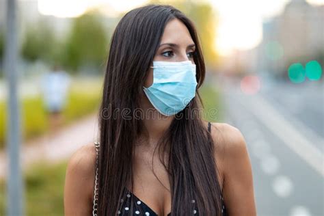 Beautiful Young Woman In Face Mask Standing In The Street Stock Image