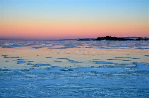 Blue Ice Of Baikal Lake Under Pink Sunset Sky Stock Photo Image Of