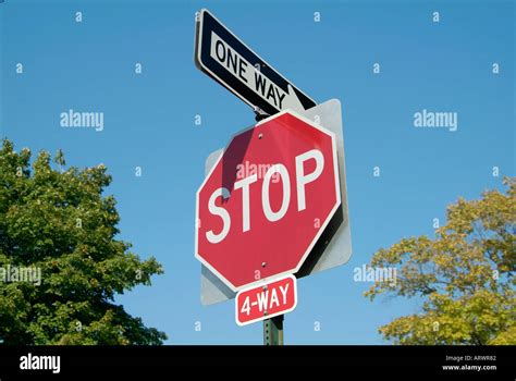 4 Way Stop Sign With One Way Arrow Stock Photo Alamy
