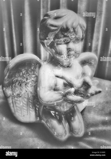 Angel Statue Holding Bird Stock Photo Alamy