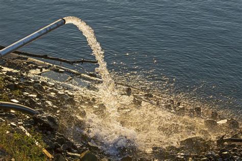 Water Flowing From A Drainage Pipe Into The River Stock Photo Image