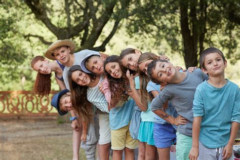 Group Portrait Of Ten Children At An Outdoors Party In A Fun Mood By
