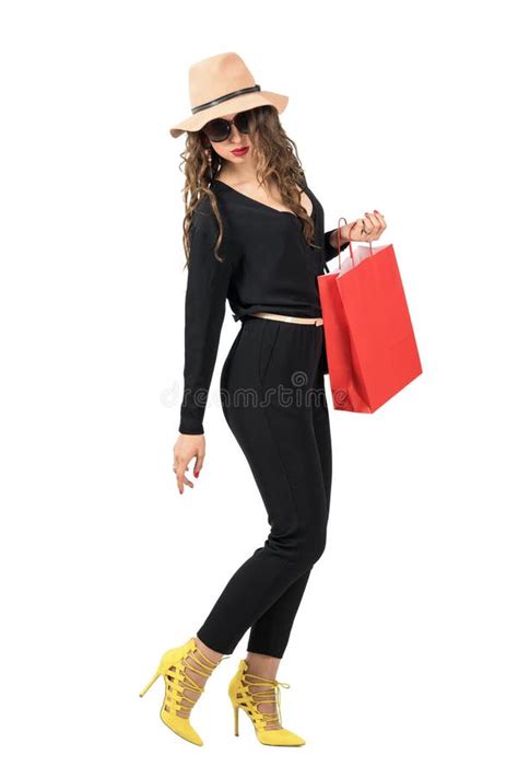 Side View Of Walking Woman With Shopping Bag Turning Back Looking Down