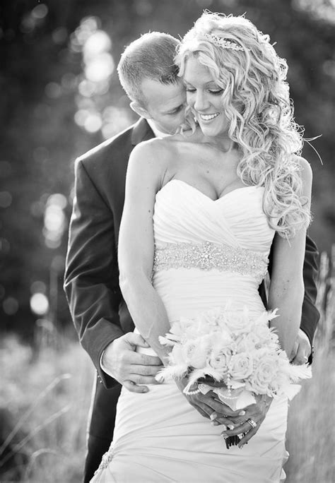 Groom Kissing Bride On Neck And Shoulder Holding Bouquet