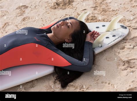 Woman Sleeping On Surfboard In The Beach Stock Photo Alamy