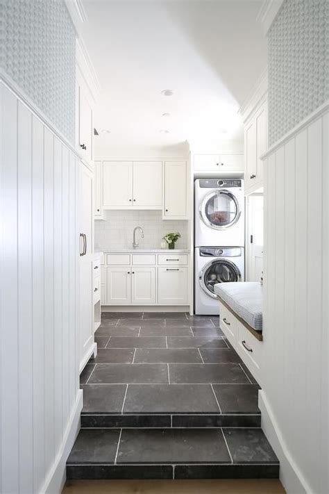 White Laundry Room with Black Staggered Floor Tiles - Transitional