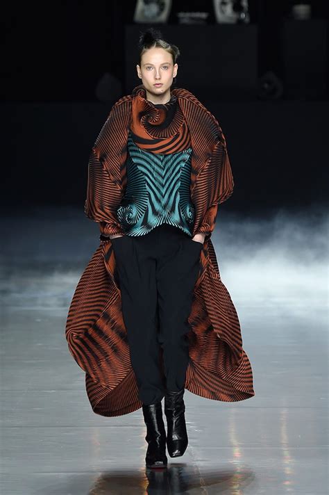 Chocolate brown coated cotton cocoon coat with detachable funnel neck, asymmetrical front button closure and two slit. #PFW Issey Miyake Fall Winter 2016/17 Collection - Design ...