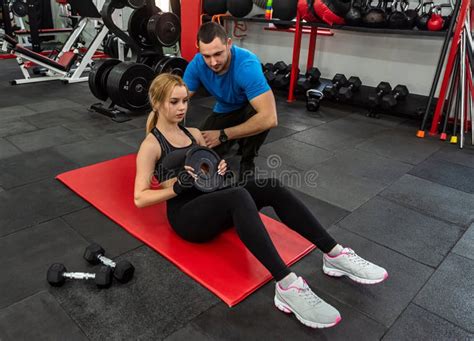 Fitness Male Trainer With His Woman Client Working Exercising At The