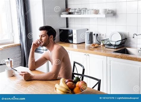 Shirtless Man Thinking While Using Digital Stock Photo Image Of Communication Beverage