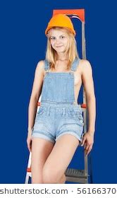 Sexy Girl Dungarees Hardhat On Stepladder Foto De Stock
