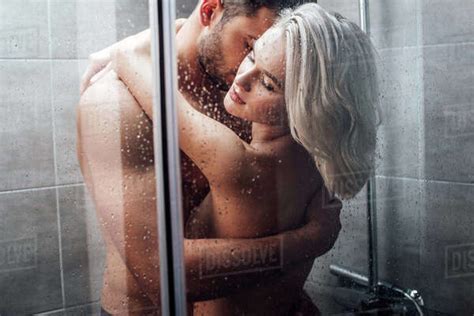Beautiful Naked Heterosexual Couple Hugging And Taking Shower Together Stock Photo Dissolve