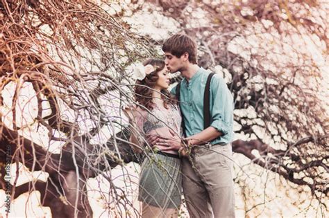 Young Couple Is Kissing Under A Tree Horizontal Buy This Stock Photo