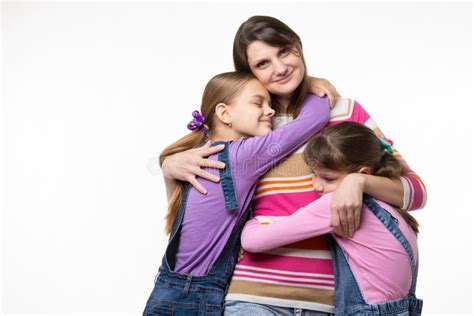 Children Hug Their Beloved Mom Mom Happily Looks In The Frame Stock
