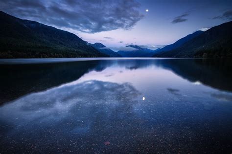 Body Of Water Between Green Mountains Under Gray Cloudy Sky Hd