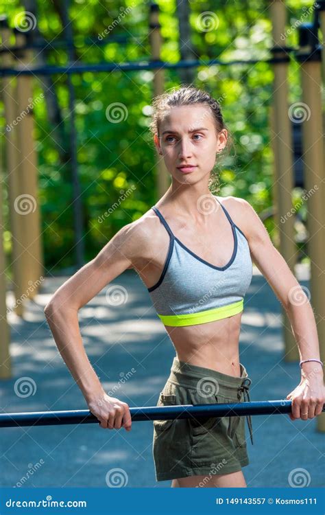 Sporty Slender Woman On Fitness Equipment On The Playground Stock Image
