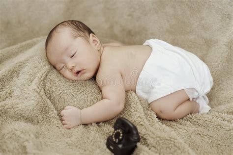 Close Up Photo Of Face Of An Asian Newborn Sleeping Happily Stock Image