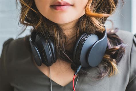 Woman Wearing Headset On Neck · Free Stock Photo