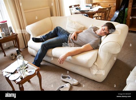 Young Man Asleep On A Sofa Stock Photo Alamy