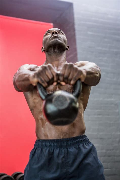 Muscular Man Lifting A Kettlebell Stock Photo Image Of Healthy
