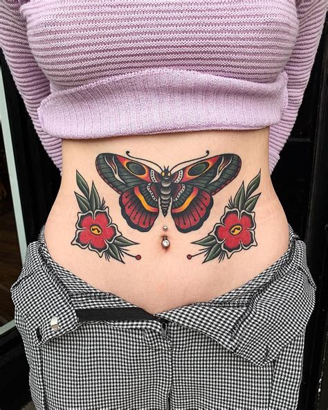 Colorful two flying birds tattoo on stomach. traditional butterfly tattoo on stomach | Stomach tattoos ...