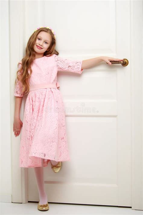 A Little Girl Is Standing By The Door Stock Image Image Of People