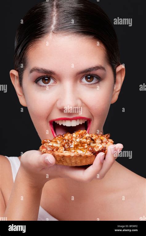 Woman Eating A Tart Stock Photo Alamy