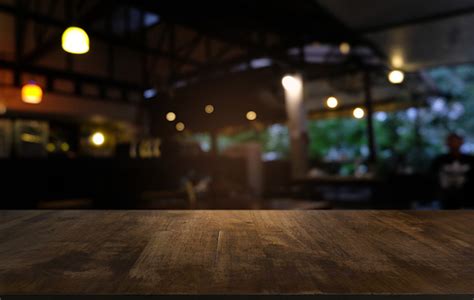 Empty Dark Wooden Table In Front Of Abstract Blurred Bokeh Background