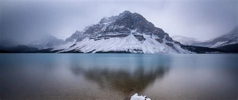 2560x1080 Snow Mountains Reflection On Lake Landscape 2560x1080
