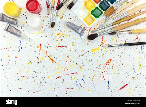 Paintbrushes Palette And Watercolor Paints On Colorful Blobs Background
