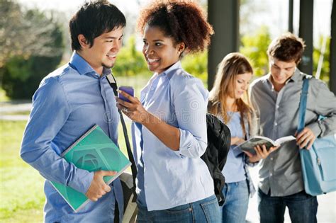 Happy Friends With Mobilephone And Book In Campus Stock Image Image
