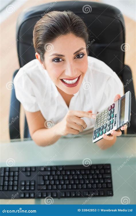 Happy Accountant Holding A Calculator Looking At Camera Stock Image