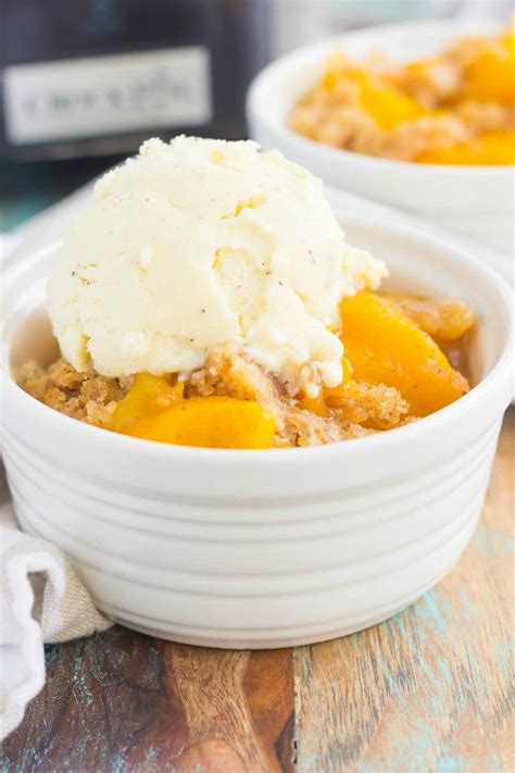 A wonderfully simple cobbler that makes its own crust! Slow Cooker Peach Cobbler | FaveSouthernRecipes.com