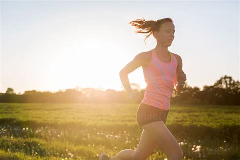 Young Athletic Woman Enjoying An Afternoon Run Stock Photo — Pixeltote