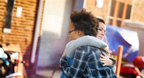 Young Women Forgiving Each Other With A Hug Stock Photo Download