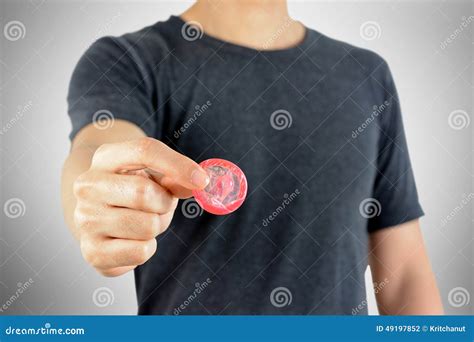 Condom In Young Woman Hand Holding Give Safe Sex Concept Prevent Infection And Contraceptives