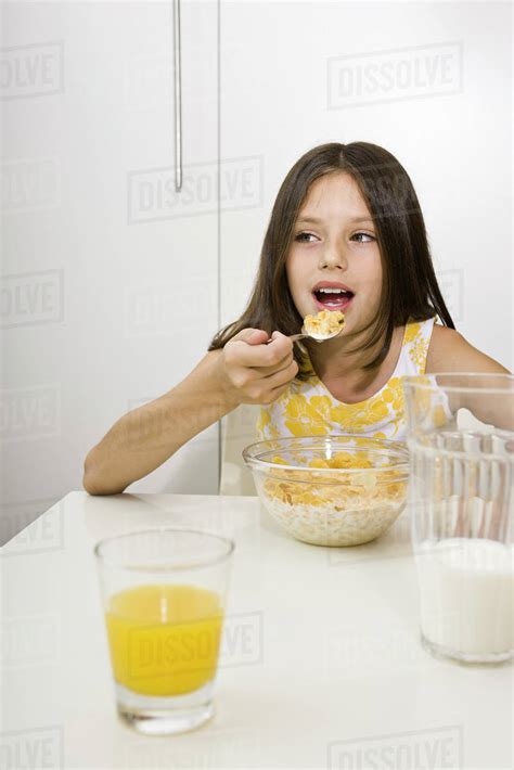 Girl Eating Cereal For Breakfast Stock Photo Dissolve