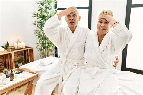 Middle Age Caucasian Couple Wearing Bathrobe At Wellness Spa Stressed And Frustrated With Hand