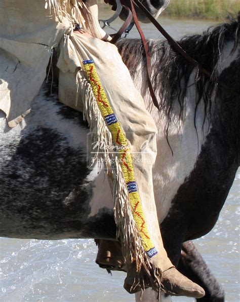 Two Native American Sioux Indian Men On Horseback Walking Throug