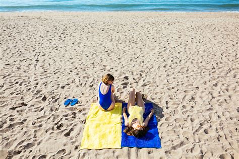 Overhead Of Female Best Friends Lying On The Beach By Stocksy Contributor Bonninstudio