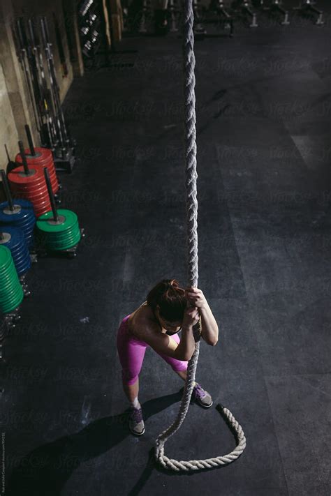 Active Fit Mixed Race Woman Recovering After Hard Ropes Workout In Gym By Stocksy Contributor