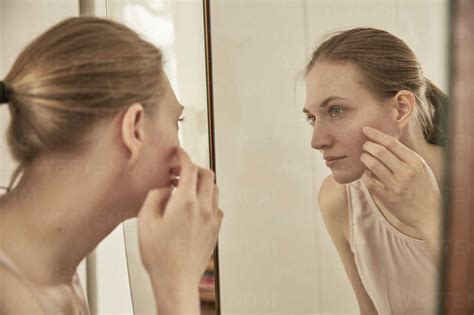 Woman Looking In Mirror Stock Photo