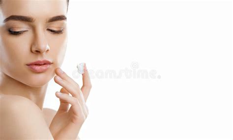 Facial Care Female Applying Cream Beauty Face Portrait Of Young Woman Closeup Of Beautiful