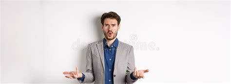 Confused And Shocked Businessman Raising Hands Up And Asking What