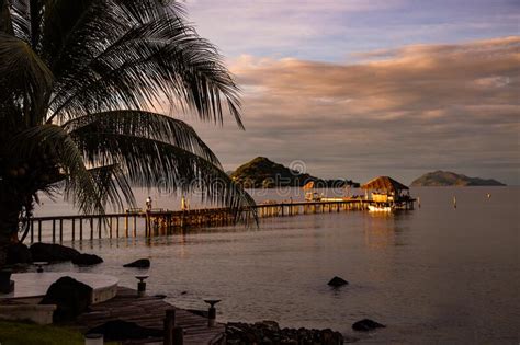 Sunset Over Wooden Beach Bar In Sea And Hut On Pier In Koh Mak Island