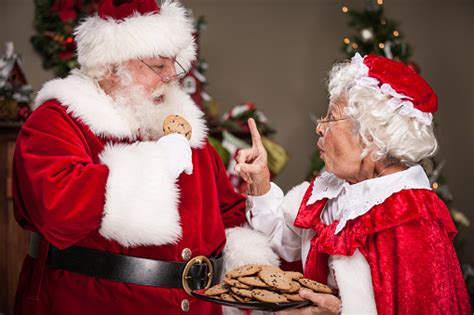 Ms Claus Scolds Santa Claus For Eating Too Many Cookies Stock Photo