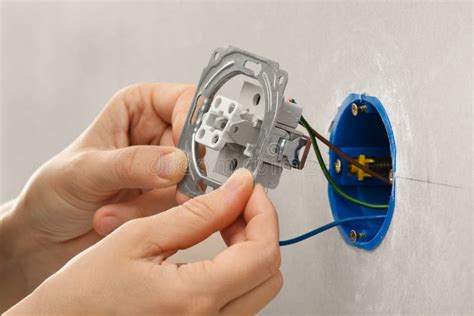Hands Installing Light Switch In Plasterboard Wall Stock Photo Image